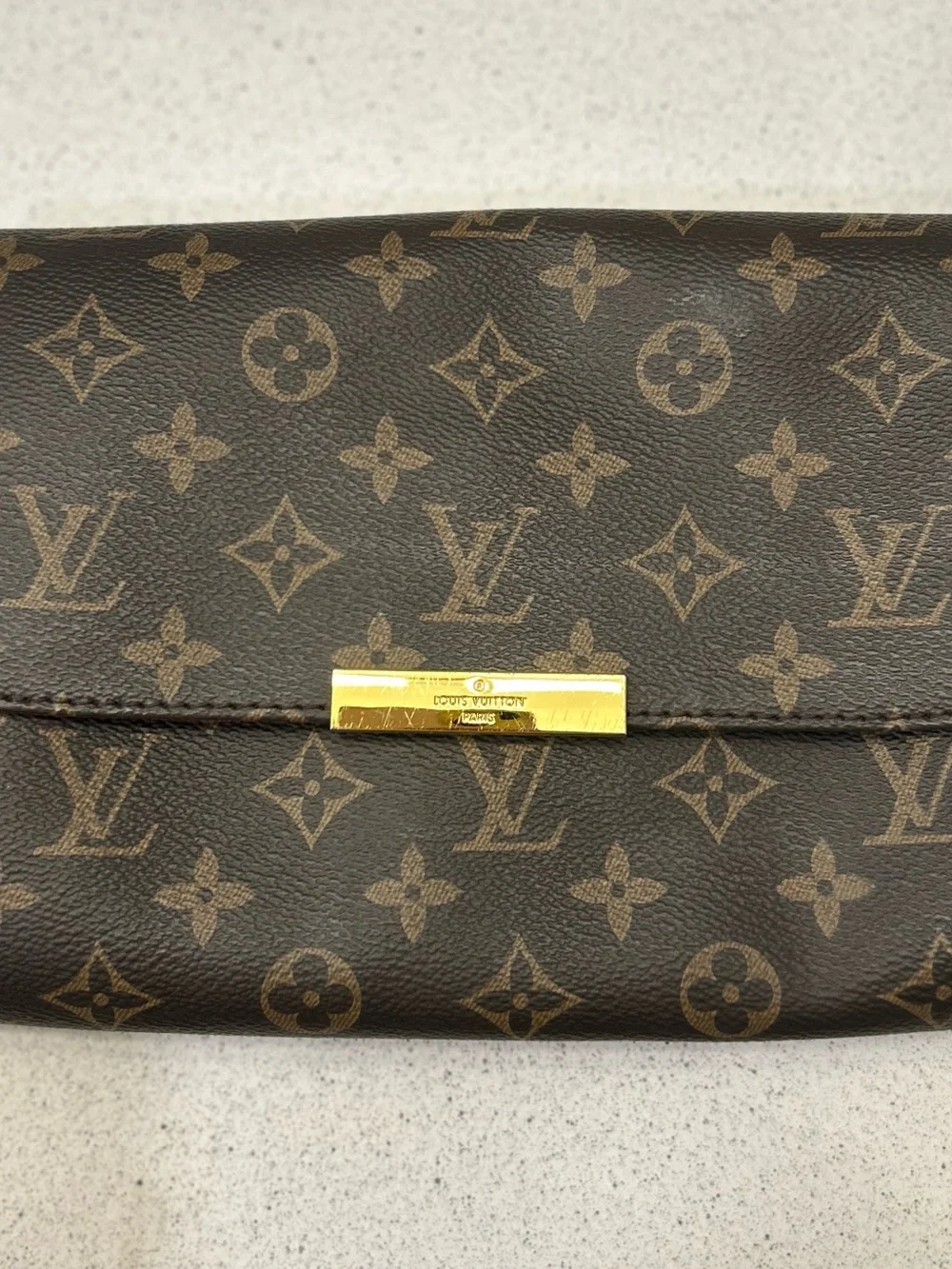 Louis Vuitton Monogram Canvas Clutch in Brown with Gold Accent